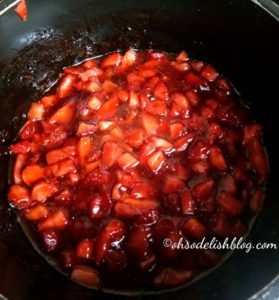 chopped strawberries in a black pan